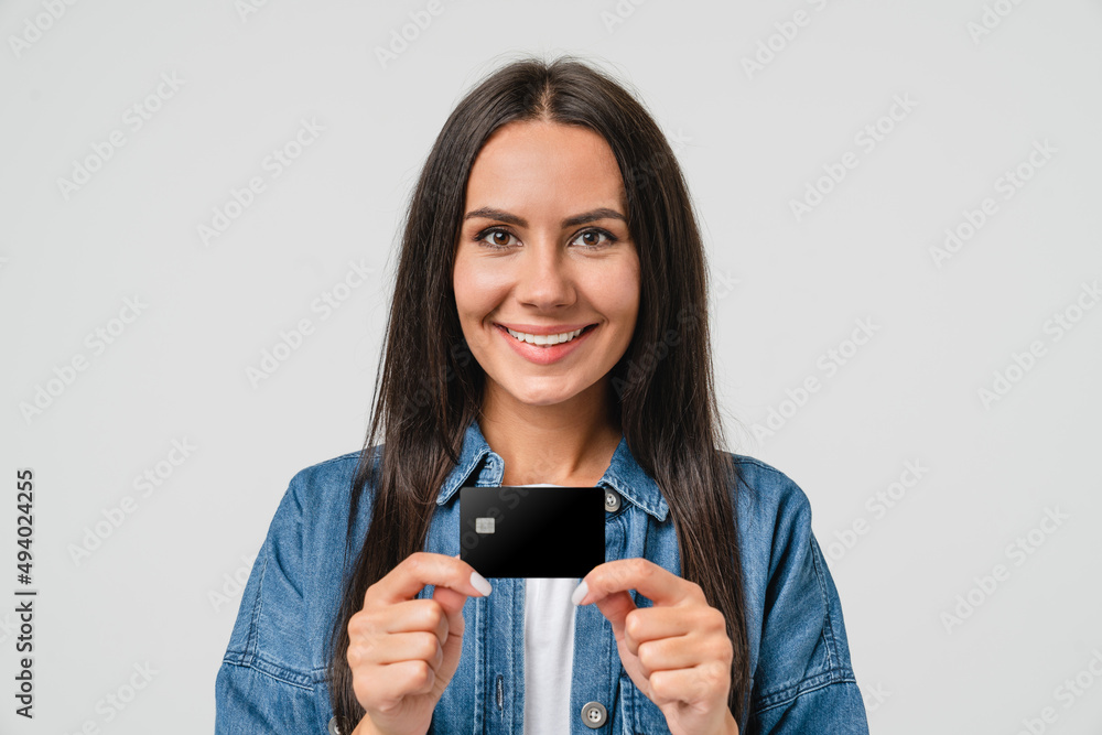 Closeup portrait of caucasian young woman bank client customer holding credit card for online payments e-commerce, transactions, cashback, loan isolated in white background Closeup portrait of caucasian young woman bank client customer holding credit card for online payments e-commerce, transactions, cashback, loan isolated in white background