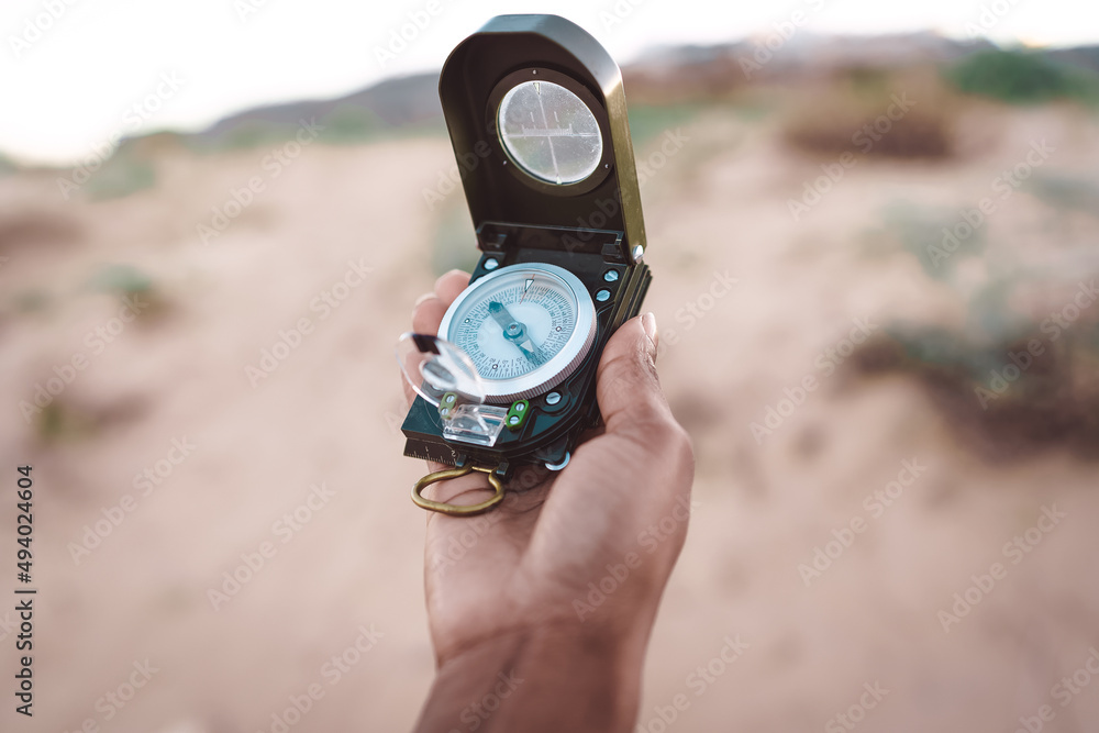 Anonymous black traveling woman with compass on seashore Anonymous black traveling woman with compass on seashore