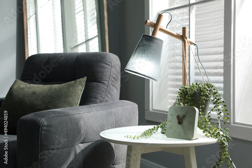 Room interior with stylish lamp and furniture