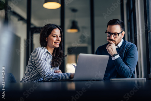 Portrait of two business colleagues, working online together.