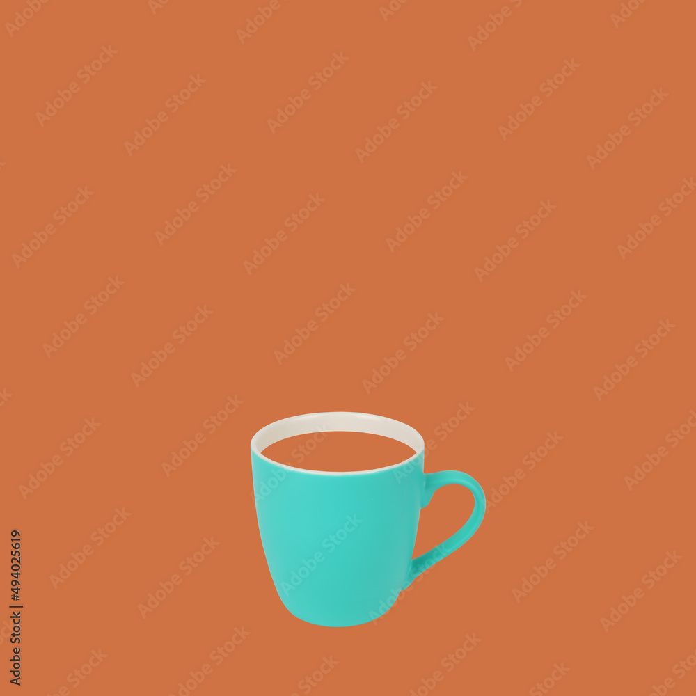 Fototapeta premium Classic green turquoise coffee mug on brown color trendy background. Retro design drinking cup of coffee concept.