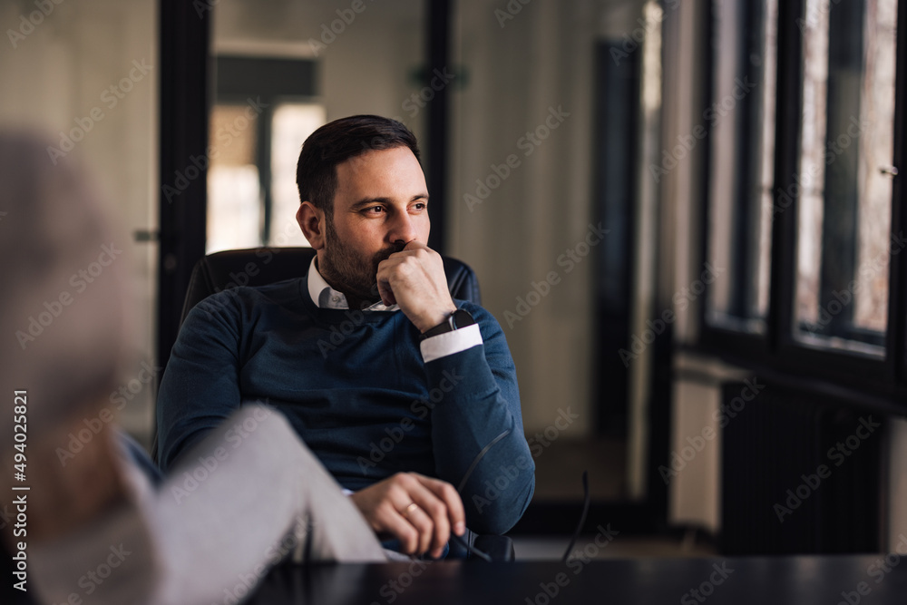Serious businessman, thinking of new plans while holding his legs on the table. Serious businessman, thinking of new plans while holding his legs on the table.