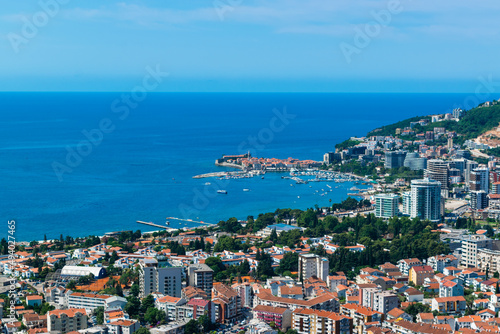 Panoramic landscape of resort Budva city on blue sky background. Top view. The architecture of the old and new city, located on Adriatic coast. Montenegro.