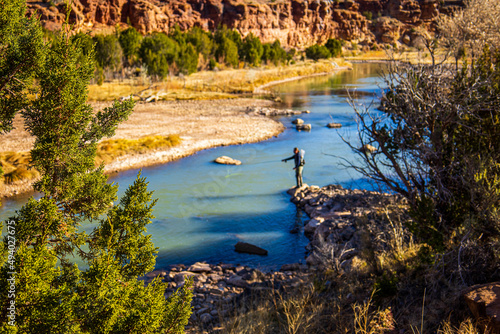 Natural landscape of the river Rio Chama and a lonely fisherman fishing along the bank photo