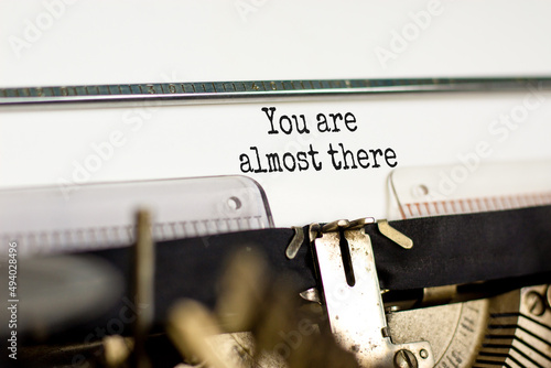 You are almost there symbol. Concept words You are almost there typed on retro typewriter. Beautiful white background. Business and you are almost there concept. Copy space. photo