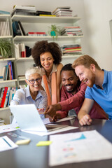 Group of successful happy multiethnic business people working as a team in office on meeting.