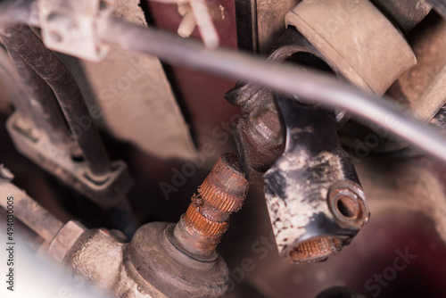 Close-up of the rusty splines and the steering shaft gimbal under the hood of the car. Car repair and maintenance.