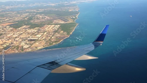 Plane flies over the ocean.