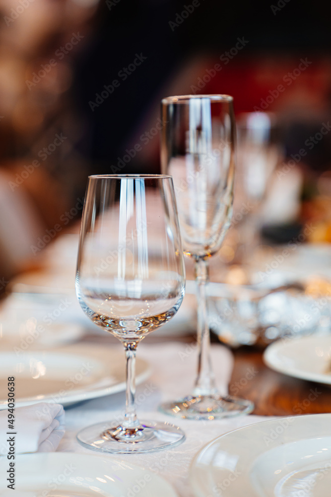 empty wine glasses on the table served for the holiday in the restaurant. tableware for home and cafe empty wine glasses on the table served for the holiday in the restaurant. tableware for home and cafe