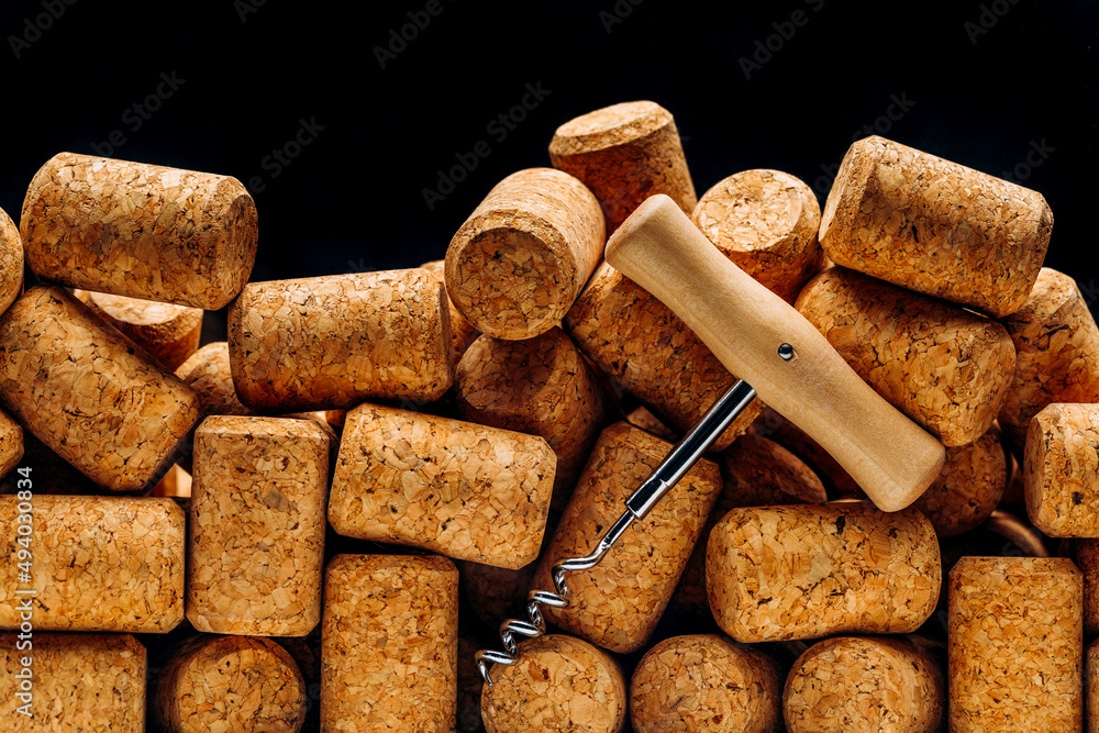 Corkscrew in Wine corks as a background. High-quality photography