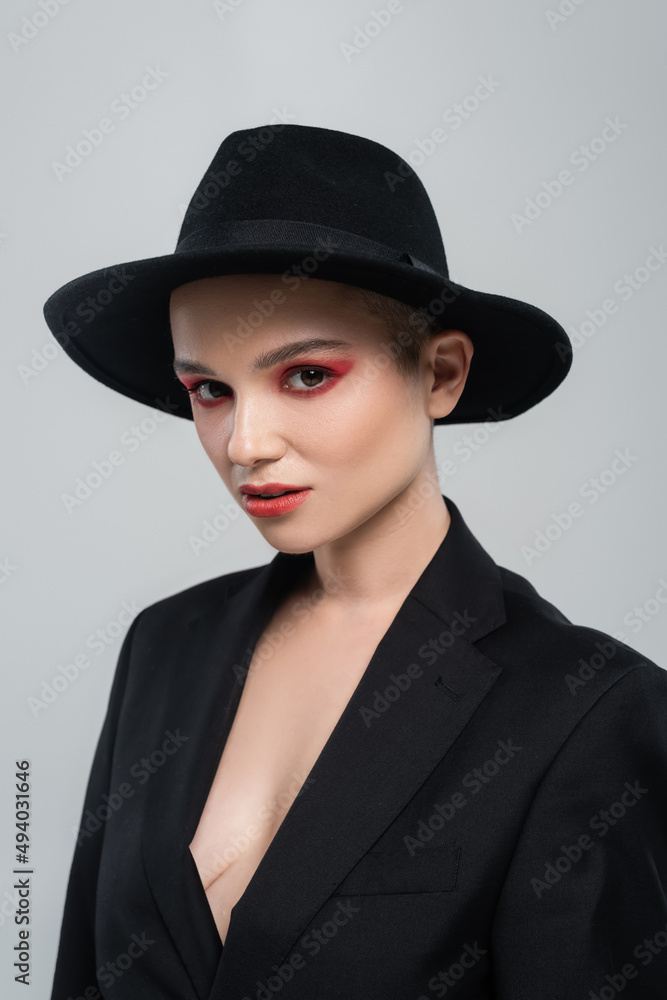 elegant woman with bright makeup looking at camera isolated on grey. elegant woman with bright makeup looking at camera isolated on grey.