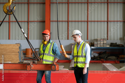 Картината върху платно Two young engineers Testing and checking the operation of the semi gantry crane