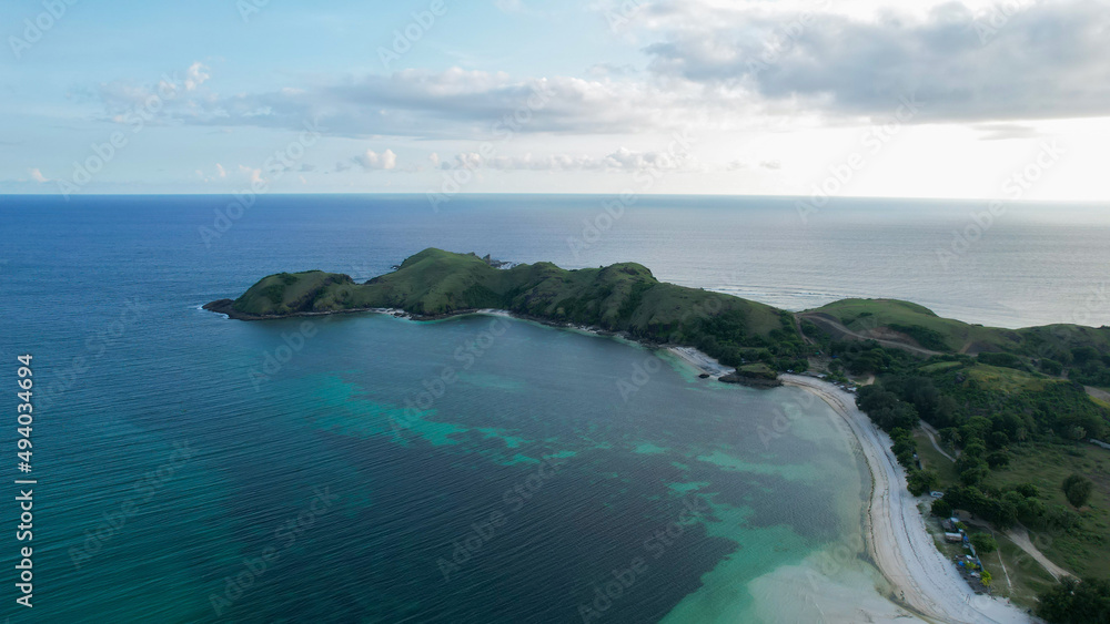 Aerial view of Tanjung Aan, Tropical island with sandy beach and turquoise ocean with waves. Lombok. Indonesia, Mach 22, 2022