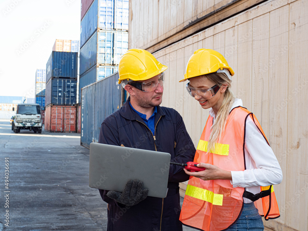 Foreman engineer female employee look at computer notebook talk discuss work job career businessman boss company office import export technology trade container logistic cargo forklift industry Foreman engineer female employee look at computer notebook talk discuss work job career businessman boss company office import export technology trade container logistic cargo forklift industry