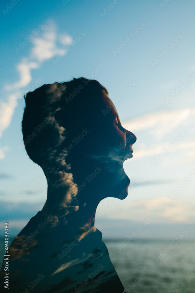 © Cavan Images - Teenage boy profile with sky and scream © Cavan Images - Teenage boy profile with sky and scream