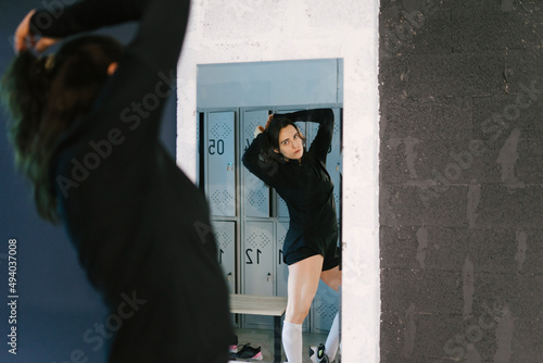 Woman in dressing room looking at herself in the mirror photo