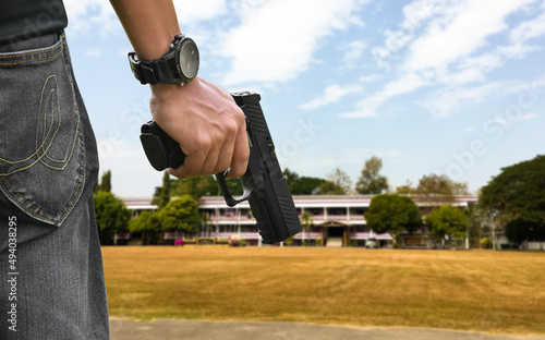 9mm automatic pistol holding in right hand of shooter, concept for security, robbery, gangster, bodyguard around the world. selective focus on pistol.