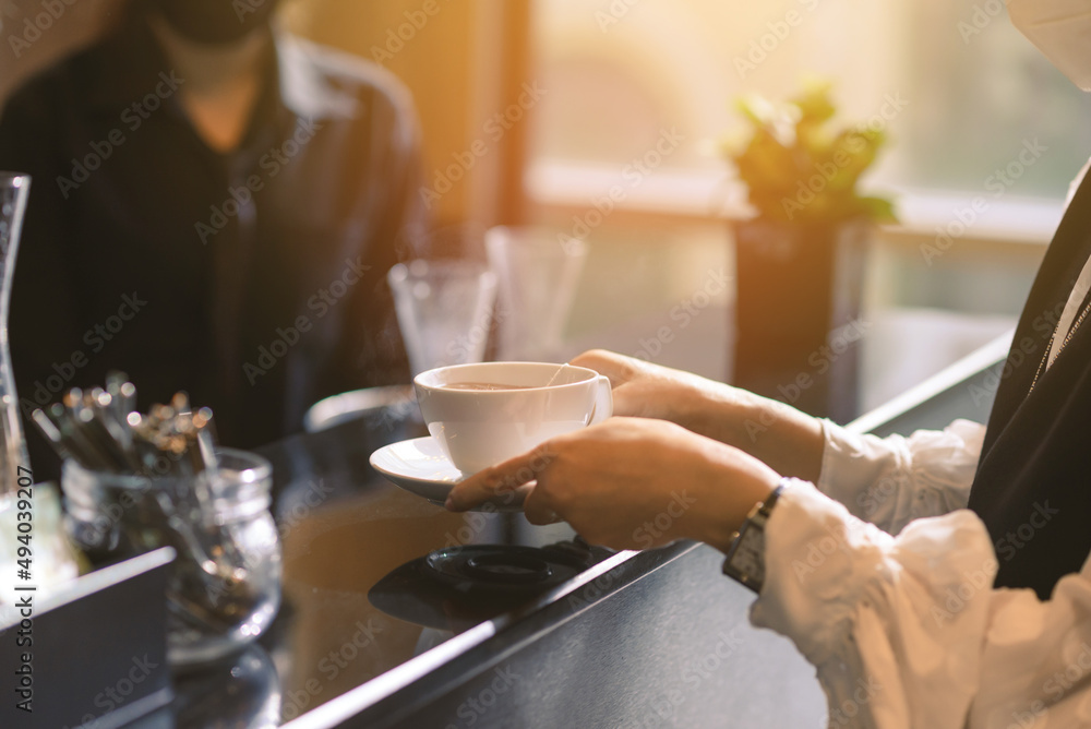 Woman hands holding hot cup of tea or coffee in modern cafe coffee shop ...
