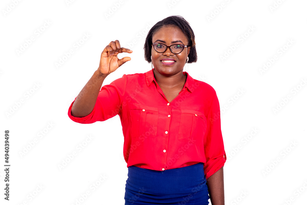 young businesswoman showing gesture a small size. young businesswoman showing gesture a small size.