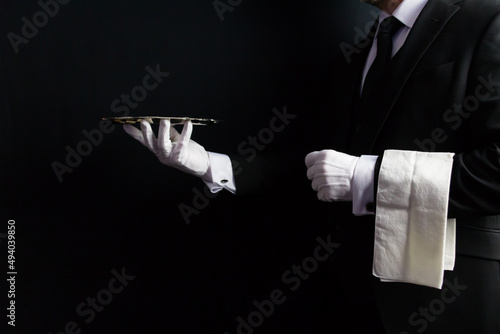 Konstfotografi Profile Portrait of Butler or Waiter in Dark Formal Suit and White Gloves Holding Serving Tray