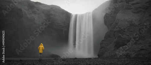 Guy with Raincoat at Skogafoss Waterfall in Iceland