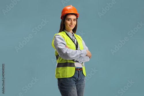 Young female site engineer with a safety vest and hardhat photo