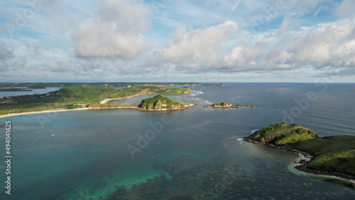Fototapeta Naklejka Na Ścianę i Meble -  Aerial view of Tanjung Aan, Tropical island with sandy beach and turquoise ocean with waves. Lombok. Indonesia, Mach 22, 2022