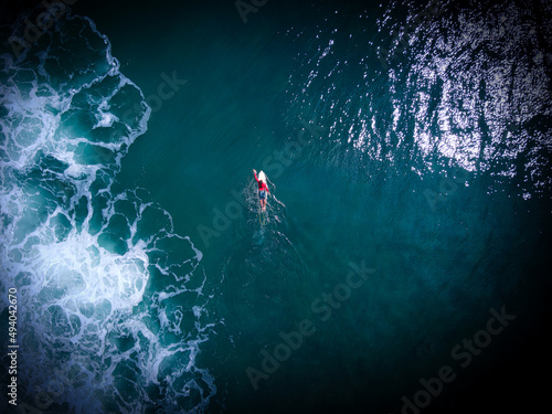 Aerial top view of a swimmer in a sea photo