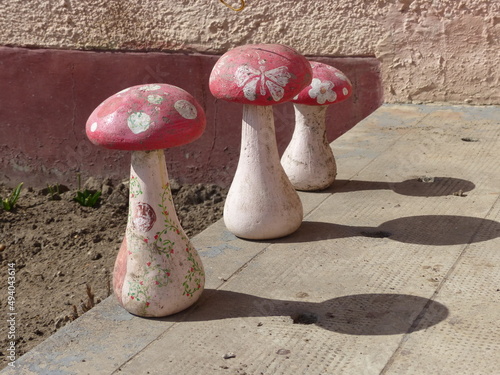 three cement mushrooms enjoying the sun