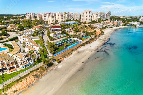 Aerial shot Dehesa de Campoamor townscape with sandy beach. Spain