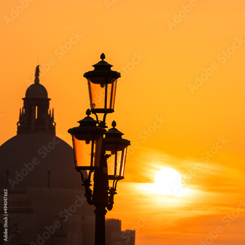 Street lamp of Venice at sunset with the Basilica of Santa Maria Della Salud in the background photo