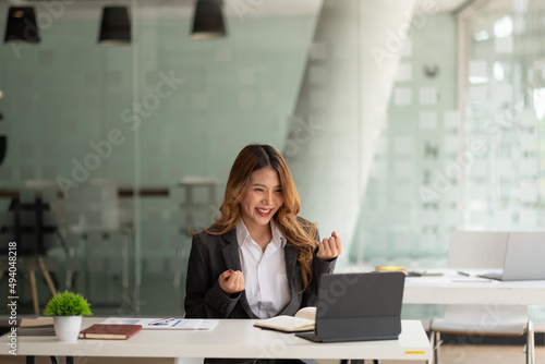 Konstfotografi Portrait attractive young asian business woman using digital tablet celebrate success or happy pose
