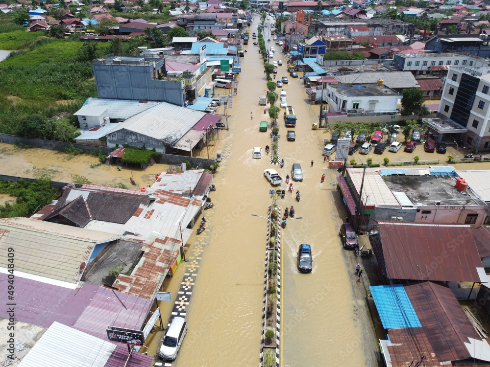 Aerial view of Situation Flood in sangatta city, east kutai, east Kalimantan, Indonesia in 21 March 2022. Floods hit homes and highways, disrupting transportation,  floods because high rainfall.