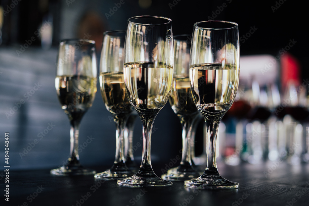 Lots of glasses of champagne in bar. Stylish, toned photo. Secular reception, new year or wedding celebration concept. Lots of glasses of champagne in bar. Stylish, toned photo. Secular reception, new year or wedding celebration concept.