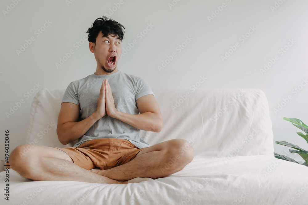 Asian man does meditation but surprised with a big distraction from the content. Asian man does meditation but surprised with a big distraction from the content.