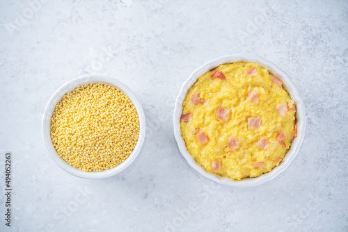 Cheesy millet with ham slices in a baking bowl