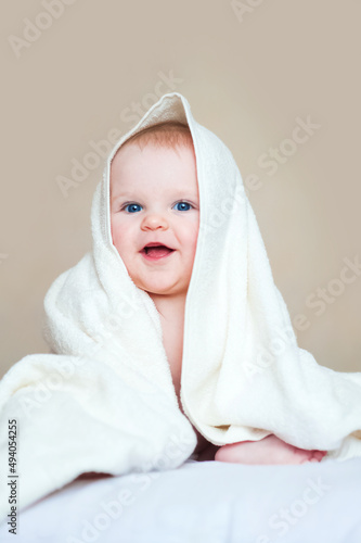 Cute baby 7 months old in white towel..