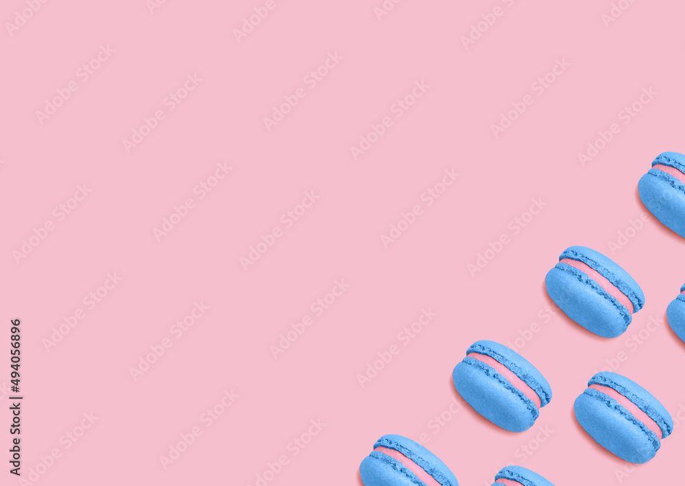 French biscuits. Top view photo. Blue colored macaroons with berry filling on pink background French biscuits. Top view photo. Blue colored macaroons with berry filling on pink background
