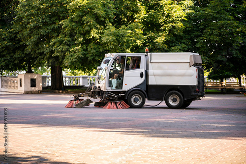 compact small washing machine in the  city street, municipal sweeper photo