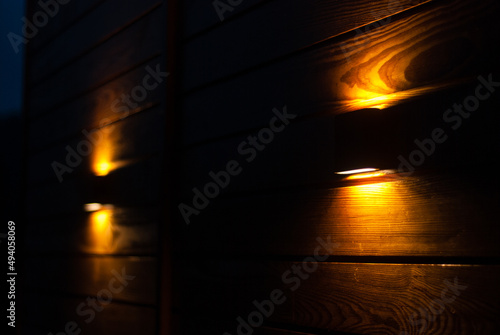 Outdoor designer wall lights shine warm light in the dark