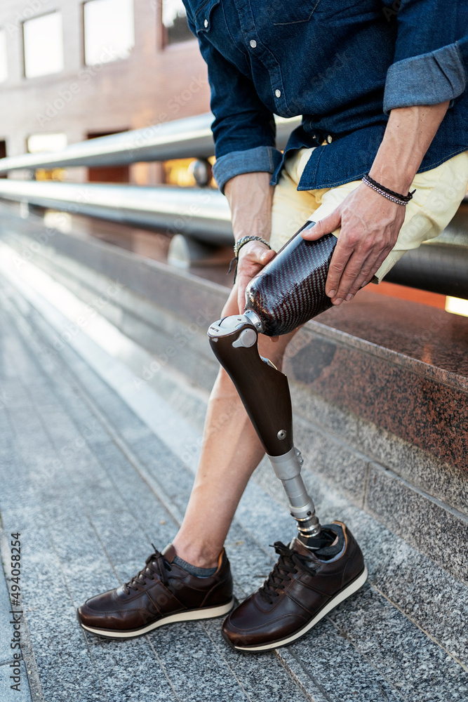 anonymous with leg prosthesis in city street anonymous with leg prosthesis in city street