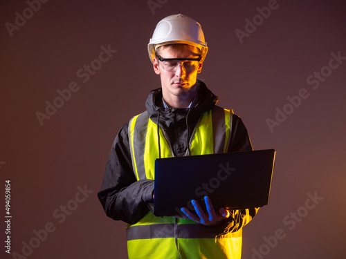 Engineer is holding laptop....