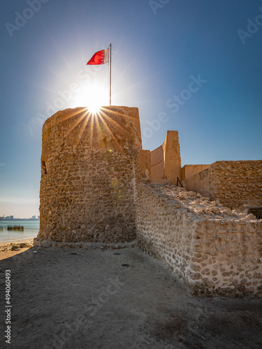 Fototapeta Old fort with the flag on top in Bahrain
