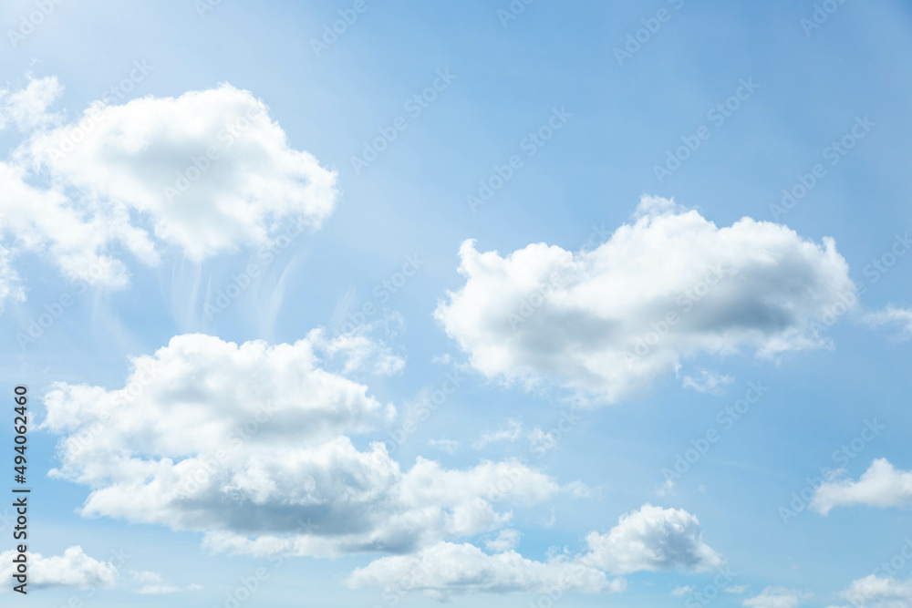 Blue sky with white clouds illuminated by daylight. The background of the blue sky. Blue sky with white clouds illuminated by daylight. The background of the blue sky.