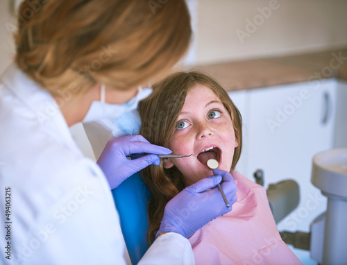 Good job opening wide. Cropped shot of a dentist examining a little girls teeth.
