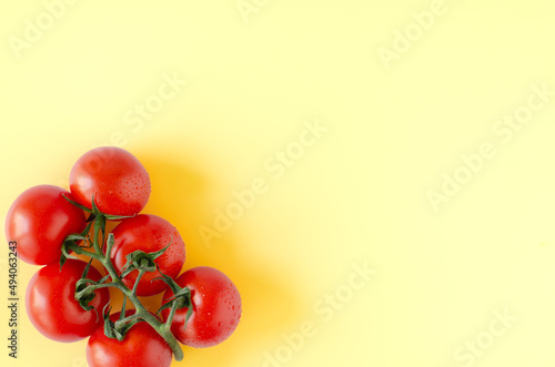 Red tomatoes on yeloww background photo