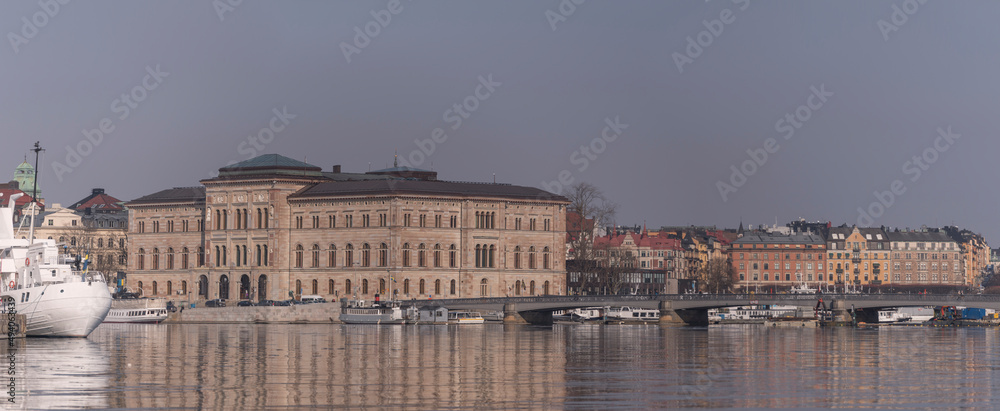 Panorama view over the bay Strömmen with boats, museums, bridge and piers a sunny spring day in Stockholm