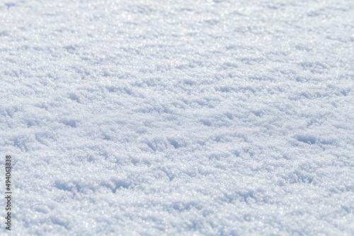 Melting wet snowdrift surface on a sunny day