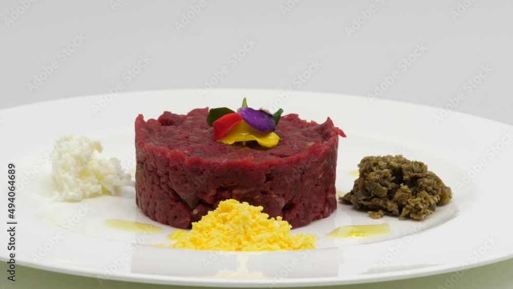Tartare di Manzo servita su un piatto, con uovo e formaggio.
Piatto che gira per mostrare la composizione di tartare di Tonno.
Tartare di Manzo servita su un piatto, con uovo e formaggio.
Piatto che gira per mostrare la composizione di tartare di Tonno.