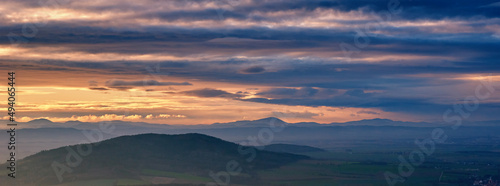 Sunset with dramatic cloudy sky over mountains shape, beautiful nature landscape